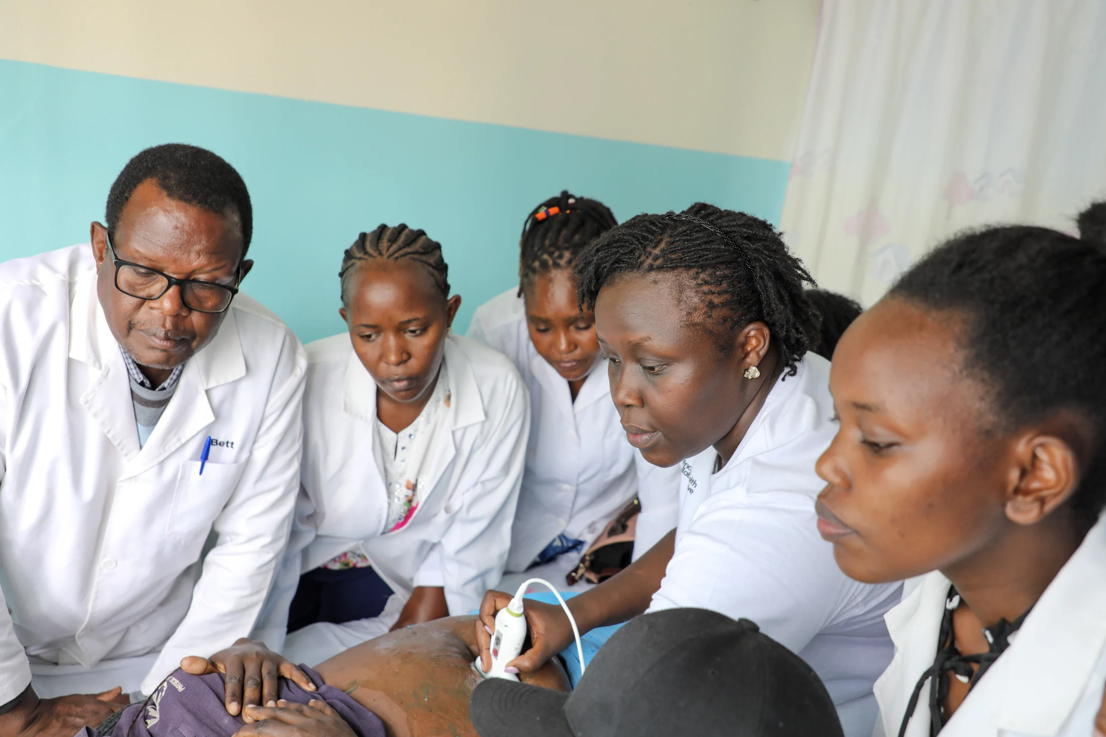 Clinicians learning ultrasound care together during practical training